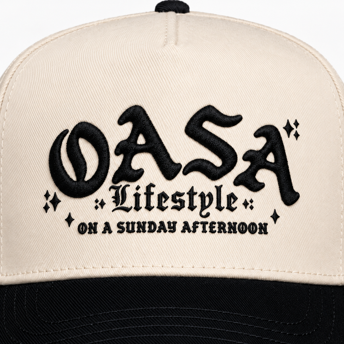 Close-up mockup of black OASA Lifestyle and On A Sunday Afternoon embroidery on natural twill